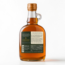 Load image into Gallery viewer, Shagbark Hickory Syrup 16 oz growler bottle with a gold wax dipped cap, green and cream Arbor and Field Label on the back with pairing suggestions and a description of how the product is crafted. Clean white background, premium look and feel.