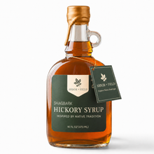 Load image into Gallery viewer, Shagbark Hickory Syrup 16 oz growler bottle with green and cream Arbor and Field Label on the front, a gold wax dipped cap and dark green gift tag hanging around the neck of the bottle  from a gold string. Clean white background, premium look and feel. 
